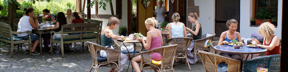 Menschen im Hof beim Ayurveda-Essen